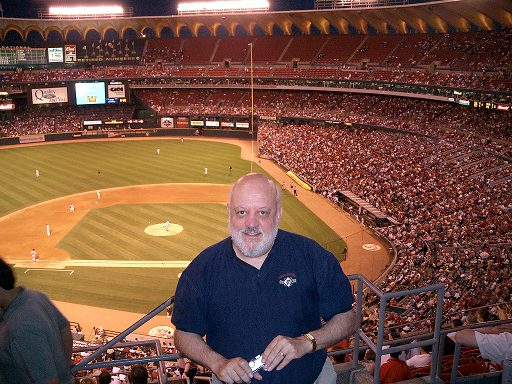 Dr. Ruspini at a baseball game in the stands with the field in the background