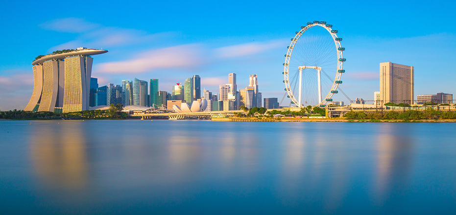 clear blue sky with skyline of buildings and Ferris wheel of Singapore